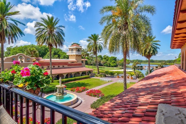 view of community featuring a water view and a lawn