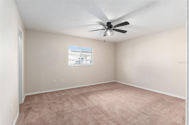 carpeted empty room with ceiling fan and a textured ceiling