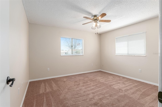 spare room featuring carpet floors, a textured ceiling, and ceiling fan