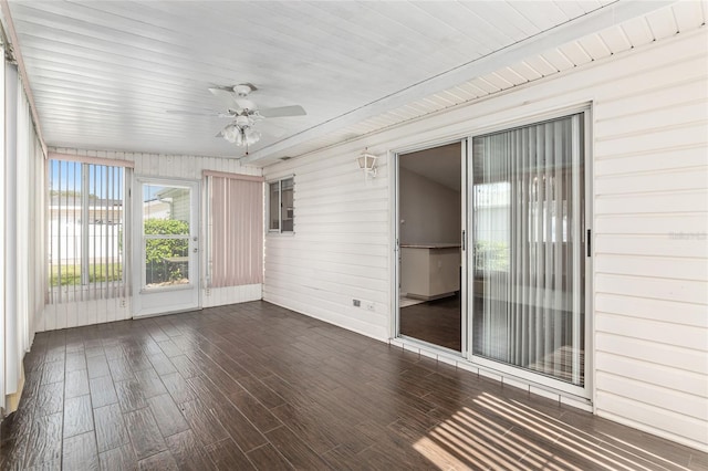 unfurnished sunroom with ceiling fan