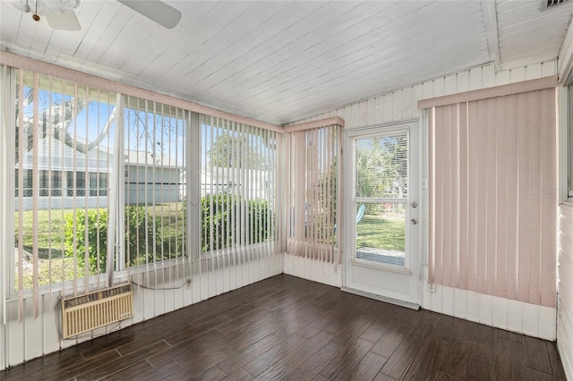 unfurnished sunroom featuring ceiling fan, wooden ceiling, and radiator