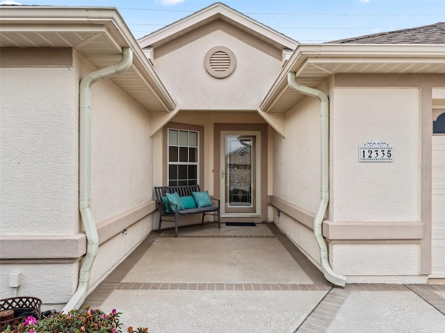 entrance to property featuring a patio area