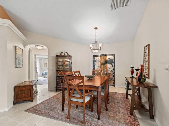 dining space with an inviting chandelier and light tile patterned flooring