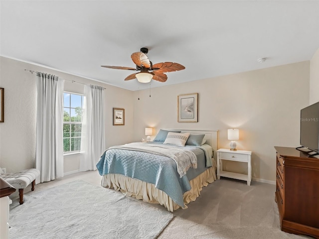 bedroom featuring light colored carpet and ceiling fan