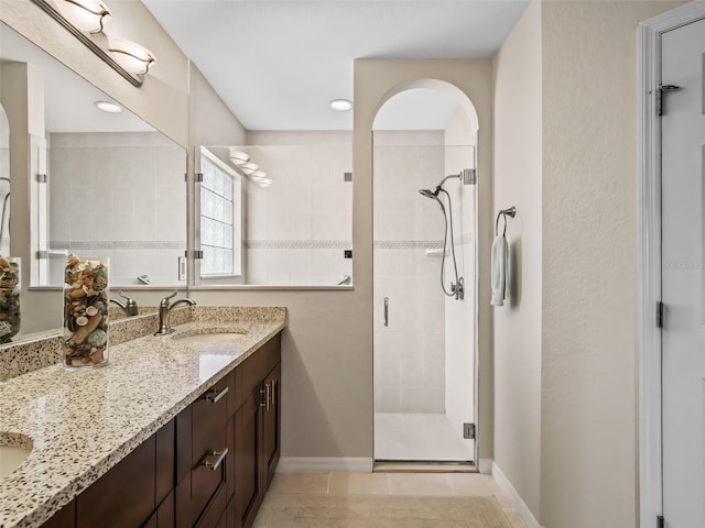 bathroom featuring vanity, tile patterned floors, and walk in shower