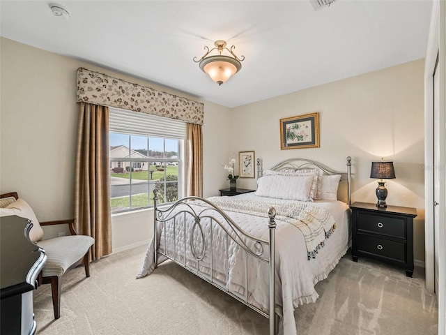 bedroom featuring light colored carpet