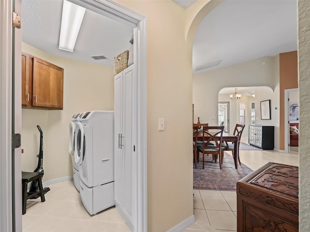 washroom with separate washer and dryer and light tile patterned floors