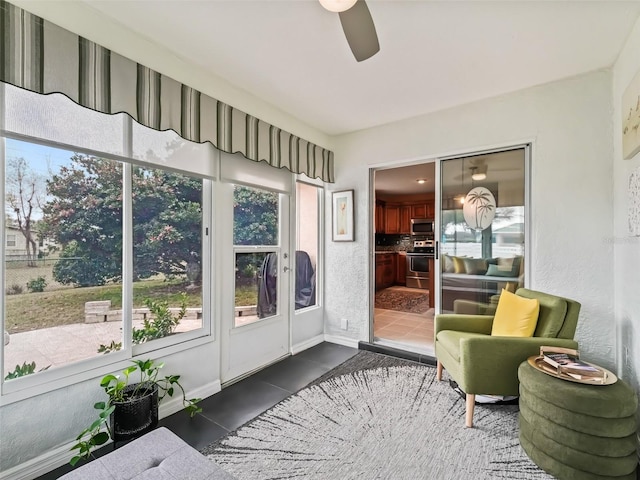 sunroom featuring ceiling fan