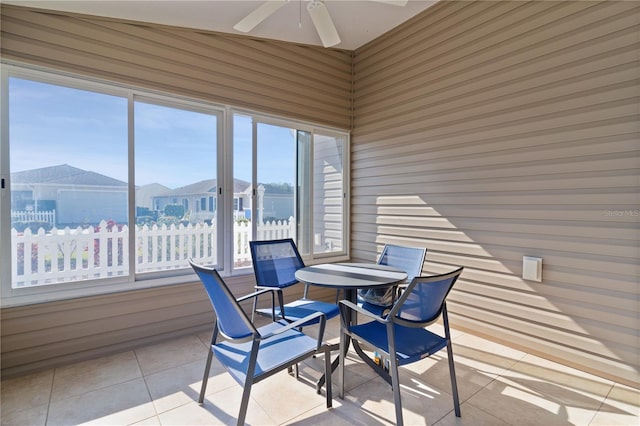 sunroom featuring ceiling fan