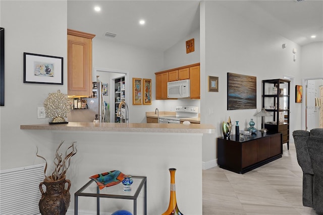 kitchen featuring sink, white appliances, high vaulted ceiling, and kitchen peninsula