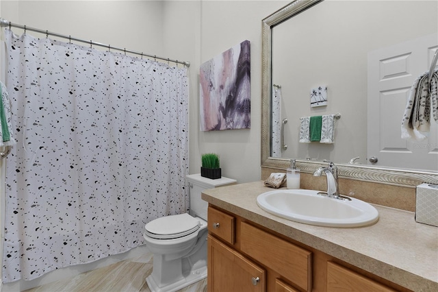 bathroom with vanity, toilet, and walk in shower