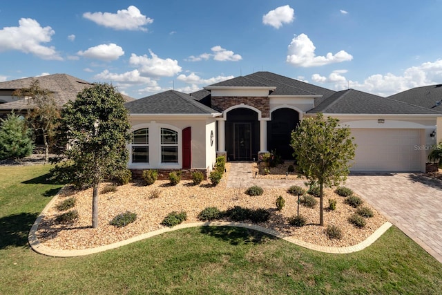 view of front of property featuring a garage and a front lawn