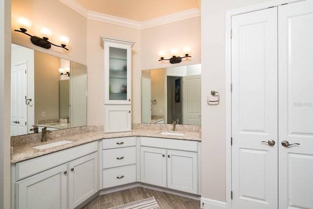 bathroom featuring vanity, hardwood / wood-style floors, and crown molding