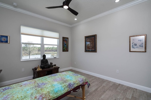 bedroom with crown molding, ceiling fan, and light wood-type flooring
