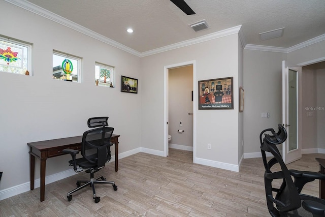 office space featuring ornamental molding, a textured ceiling, and light wood-type flooring
