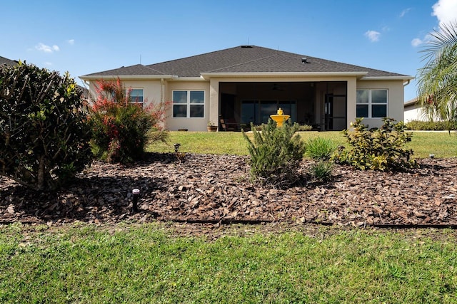 rear view of house featuring a yard