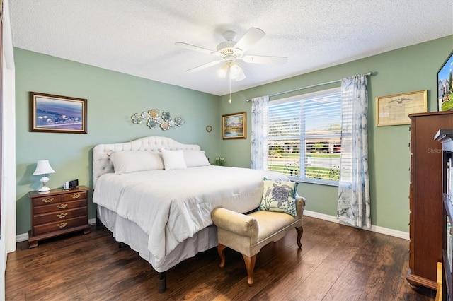 bedroom with dark hardwood / wood-style flooring, ceiling fan, and a textured ceiling