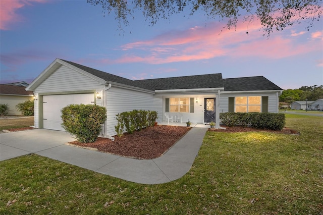 ranch-style home featuring a yard, a garage, and a porch