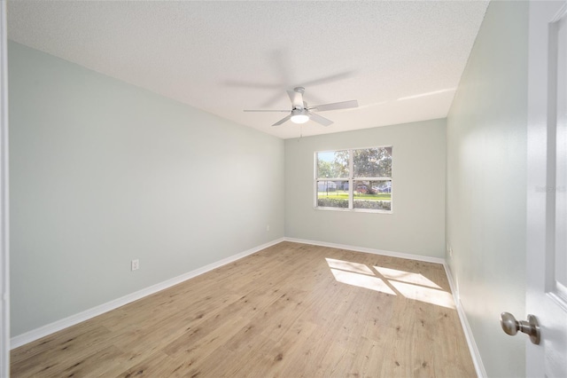 spare room featuring ceiling fan, light hardwood / wood-style floors, and a textured ceiling
