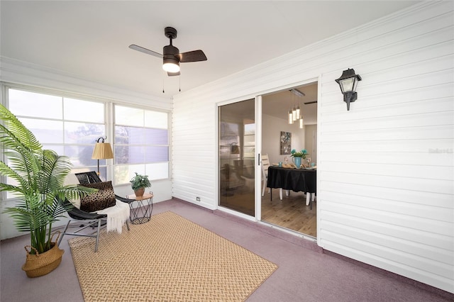 sunroom / solarium featuring ceiling fan