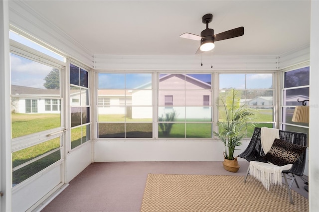 sunroom / solarium featuring ceiling fan