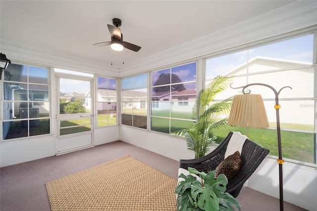unfurnished sunroom with ceiling fan