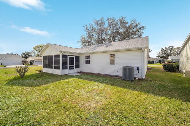 back of house featuring central AC, a yard, and a sunroom