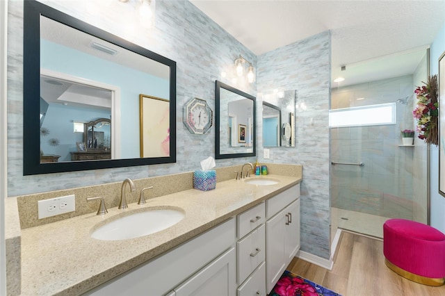 6576 Merrill Ln, The Villages, FL 34762 - full bath with visible vents, a sink, a tile shower, and wood finished floors
