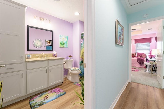 6576 Merrill Ln, The Villages, FL 34762 - bathroom with vanity, toilet, baseboards, visible vents, and wood finished floors