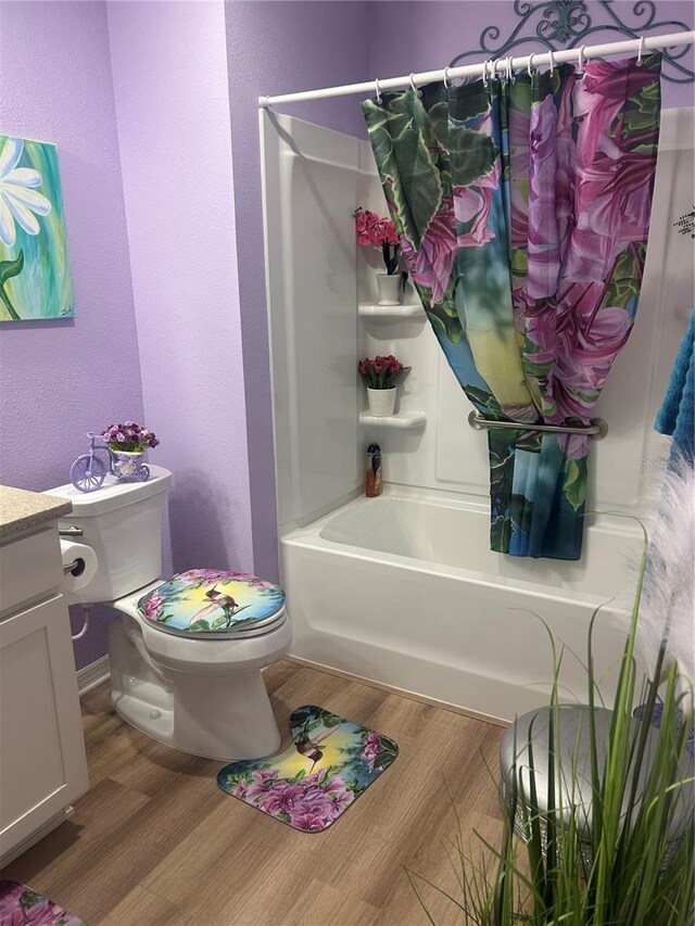 6576 Merrill Ln, The Villages, FL 34762 - bathroom featuring toilet, vanity, shower / bath combo with shower curtain, and wood finished floors