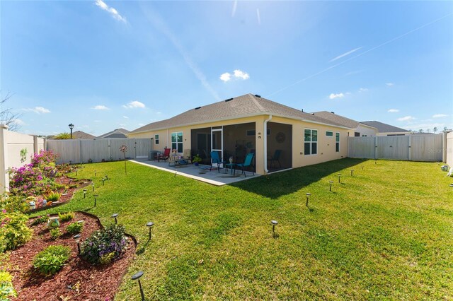 6576 Merrill Ln, The Villages, FL 34762 - rear view of house with a lawn, a fenced backyard, stucco siding, and a patio area