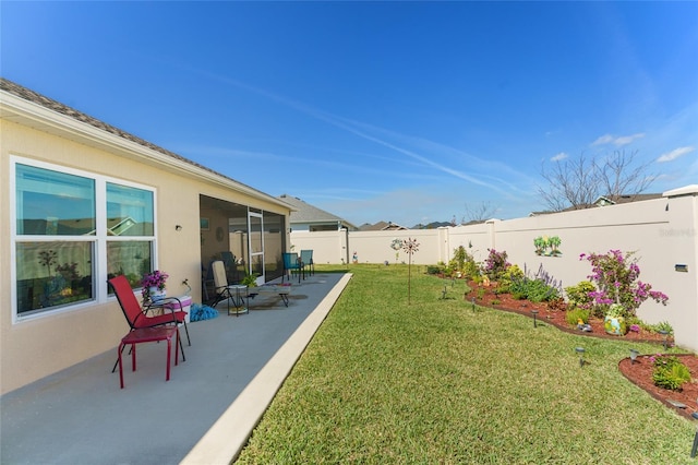 6576 Merrill Ln, The Villages, FL 34762 - view of yard featuring a patio, a sunroom, and a fenced backyard