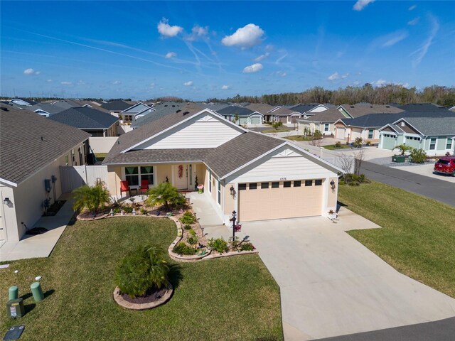 6576 Merrill Ln, The Villages, FL 34762 - ranch-style house featuring a residential view, a front yard, a garage, and a shingled roof