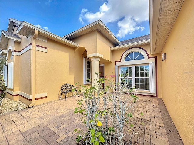 entrance to property featuring a patio