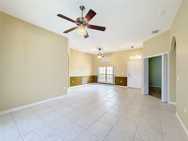 unfurnished room with light tile patterned floors and ceiling fan