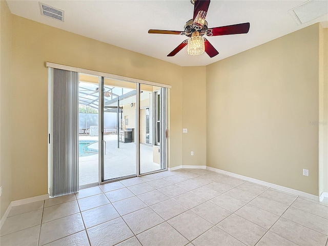 tiled empty room featuring ceiling fan