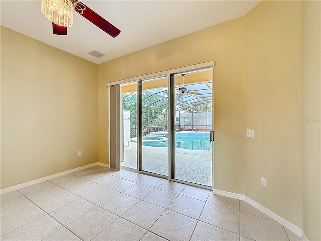 tiled empty room with ceiling fan