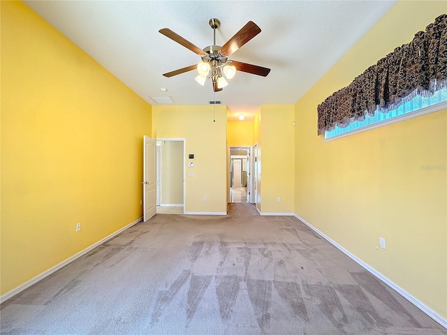 unfurnished bedroom with light carpet, ensuite bath, and ceiling fan