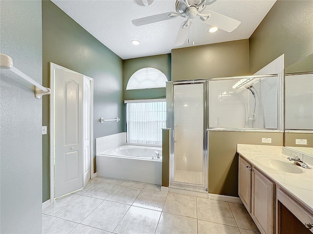 bathroom with ceiling fan, vanity, a textured ceiling, tile patterned floors, and separate shower and tub