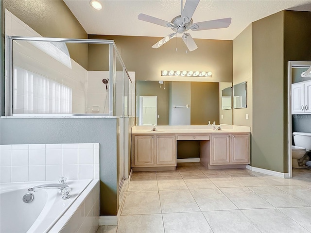 full bathroom featuring plus walk in shower, vanity, ceiling fan, toilet, and tile patterned floors