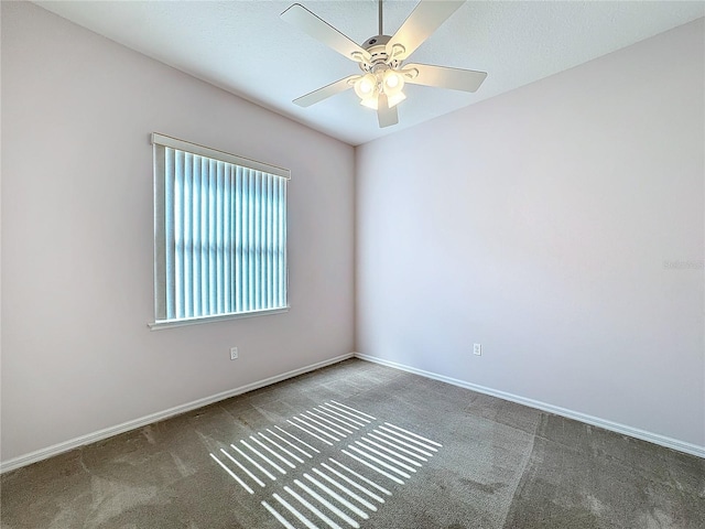 carpeted empty room featuring ceiling fan