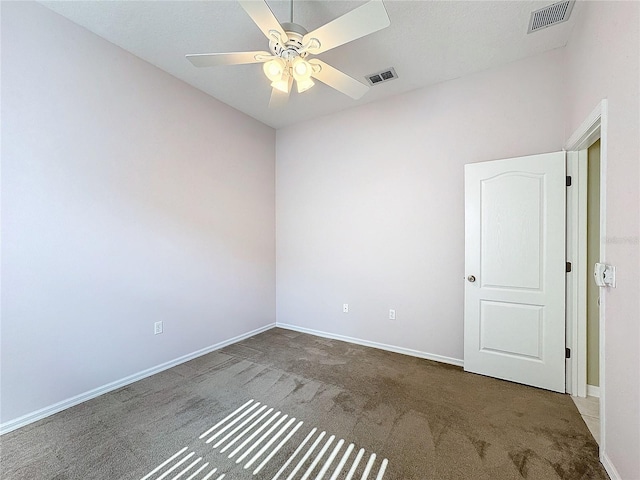 carpeted spare room featuring ceiling fan