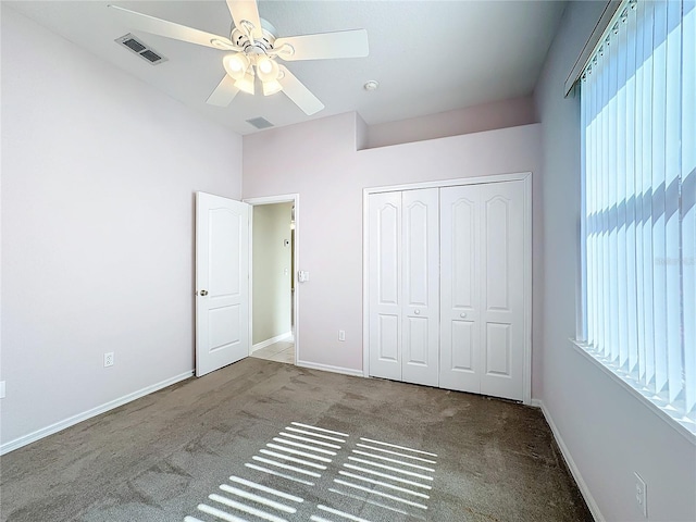 unfurnished bedroom with carpet floors, a closet, and ceiling fan