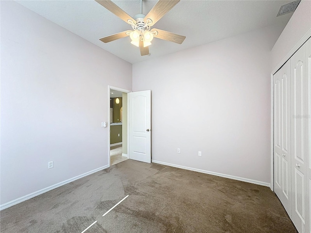 unfurnished bedroom featuring a closet, ceiling fan, and carpet