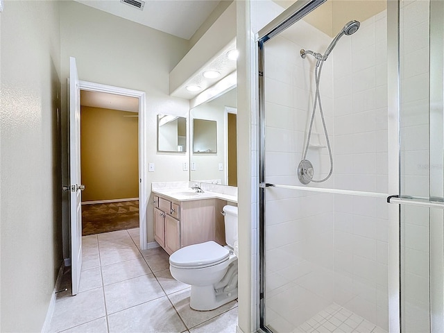 bathroom with tile patterned floors, vanity, toilet, and an enclosed shower