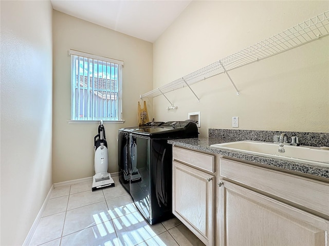 laundry room featuring cabinets, independent washer and dryer, sink, and light tile patterned floors