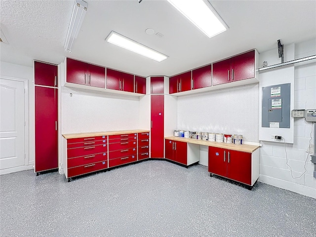 interior space with electric panel and a textured ceiling