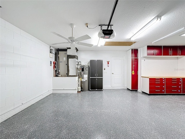 garage with heating unit, a garage door opener, electric water heater, and ceiling fan