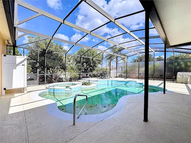 view of swimming pool featuring an in ground hot tub, a lanai, and a patio area