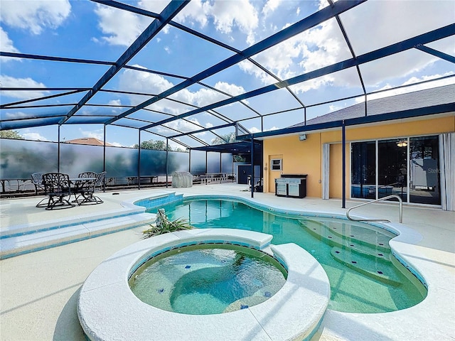 view of swimming pool featuring an in ground hot tub, a lanai, and a patio